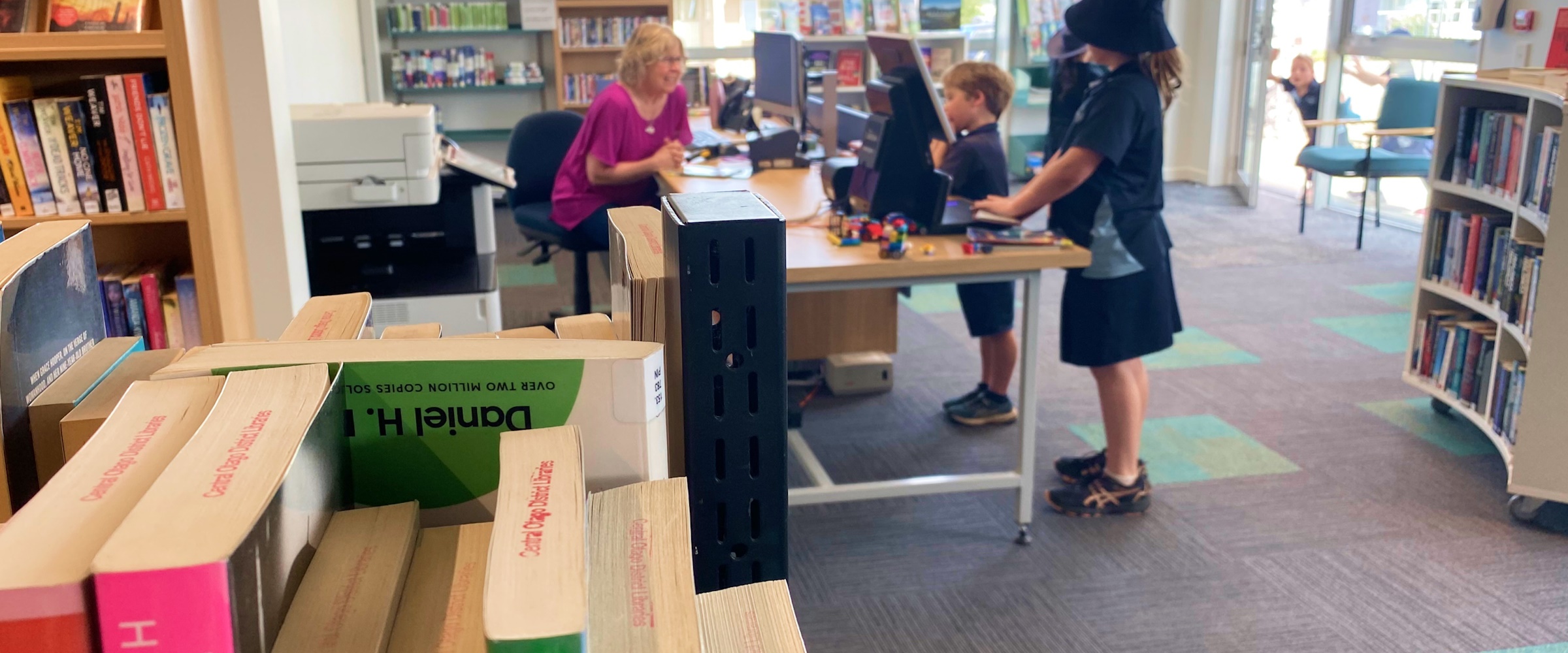 Kids at the library counter with Librarian